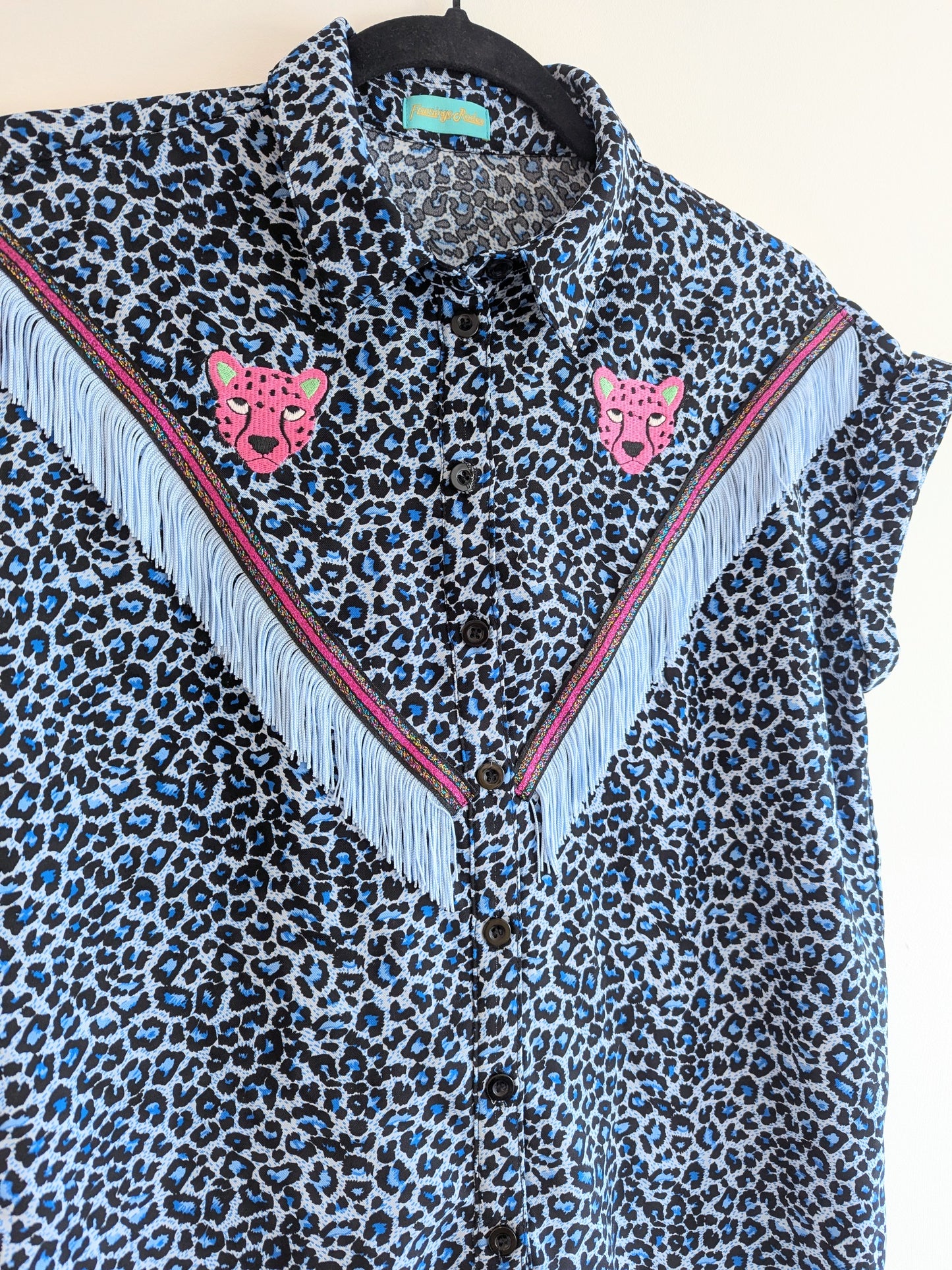 blue leopard print shirt with embroidery pink leopard faces above cowboy western style powder blue tassel trim