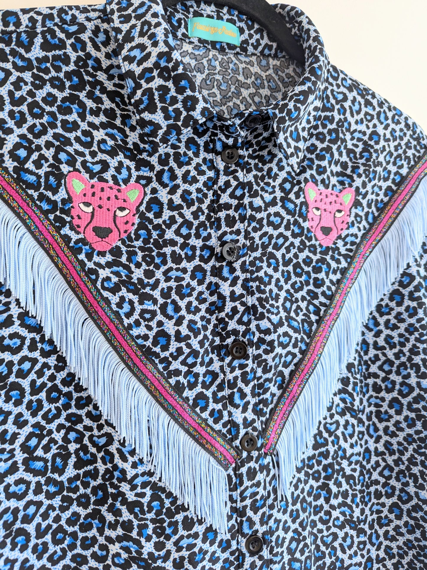 blue leopard print shirt with embroidery pink leopard faces above cowboy western style fringe trim