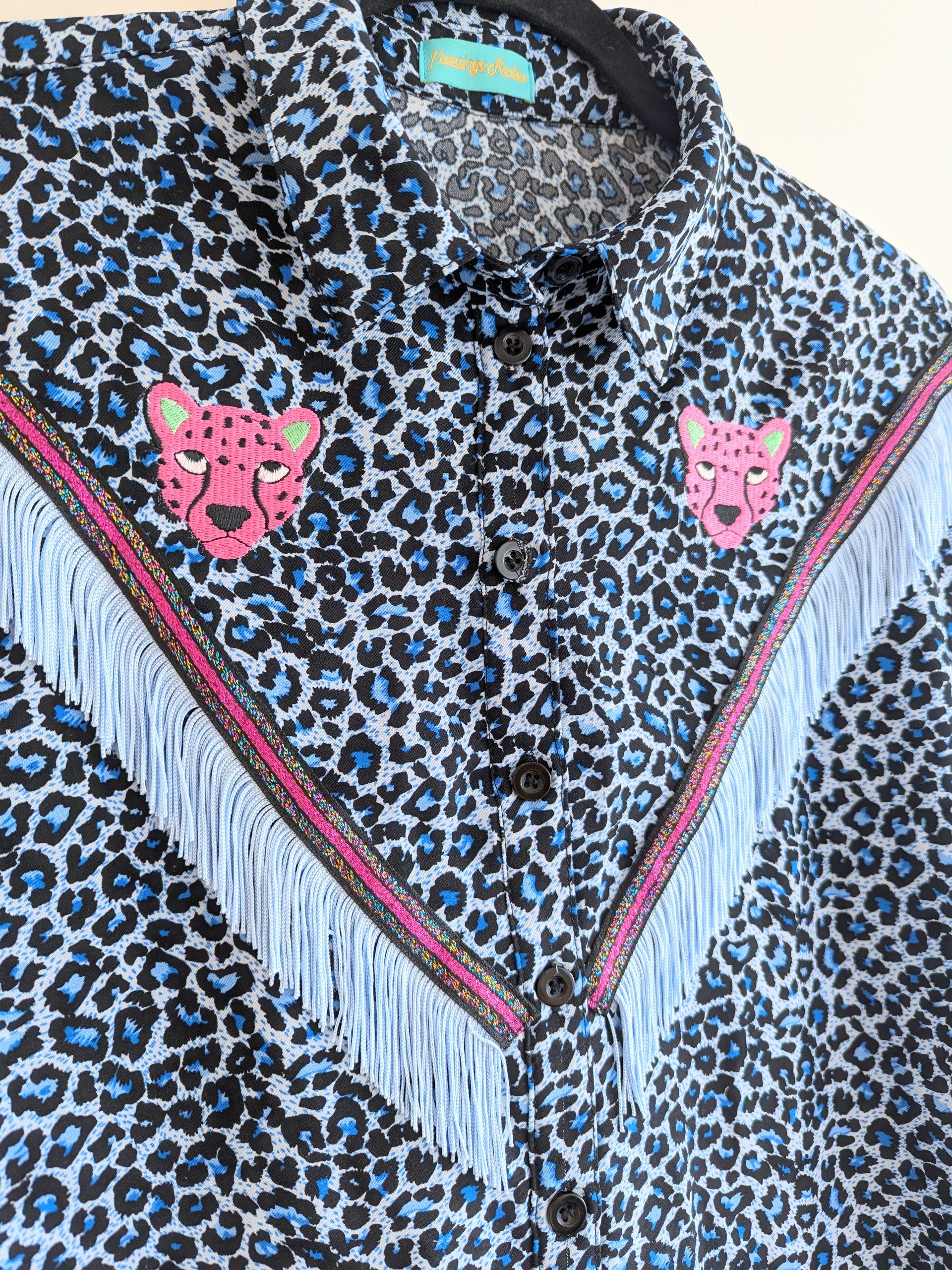 blue leopard print shirt with embroidery pink leopard faces above cowboy western style fringe trim
