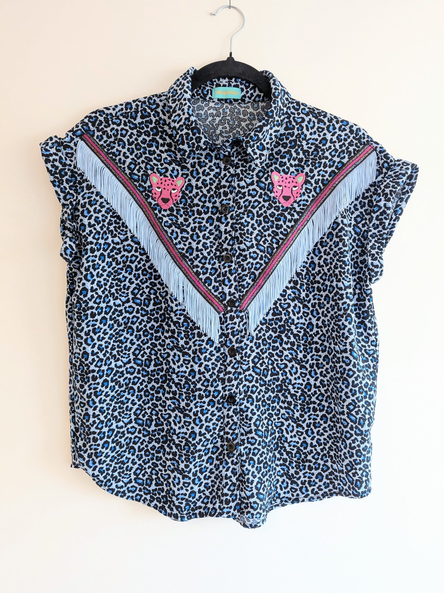 blue leopard print shirt with embroidery pink leopard faces above cowboy western style powder blue tassel trim