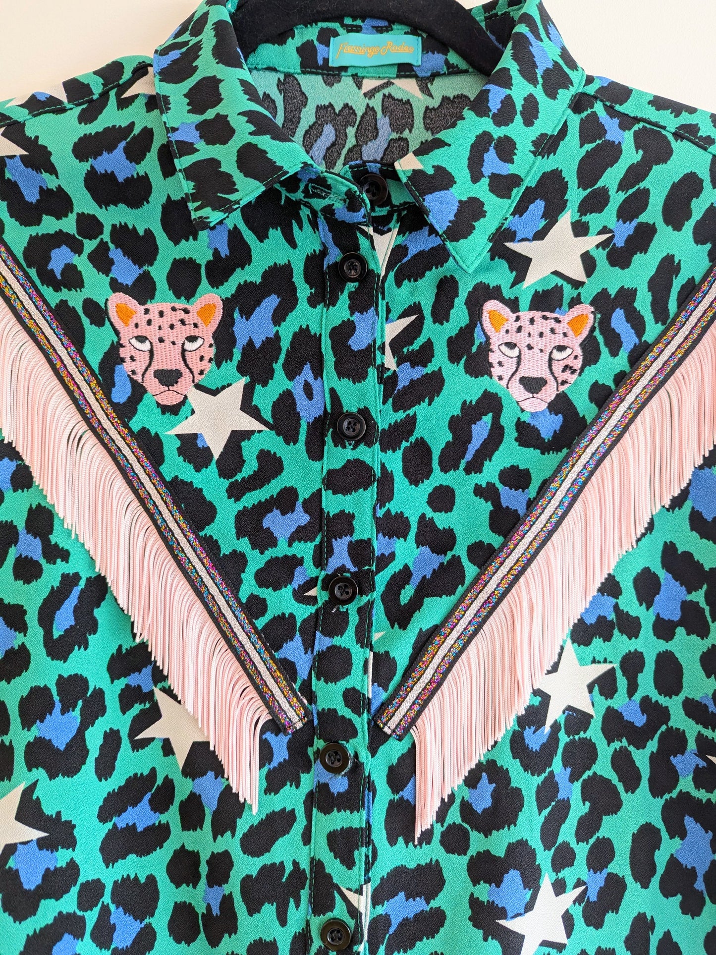 Green shirt with leopard print and star patterns. It has embroidery pink leopards and western style pale pink fringe trim added.