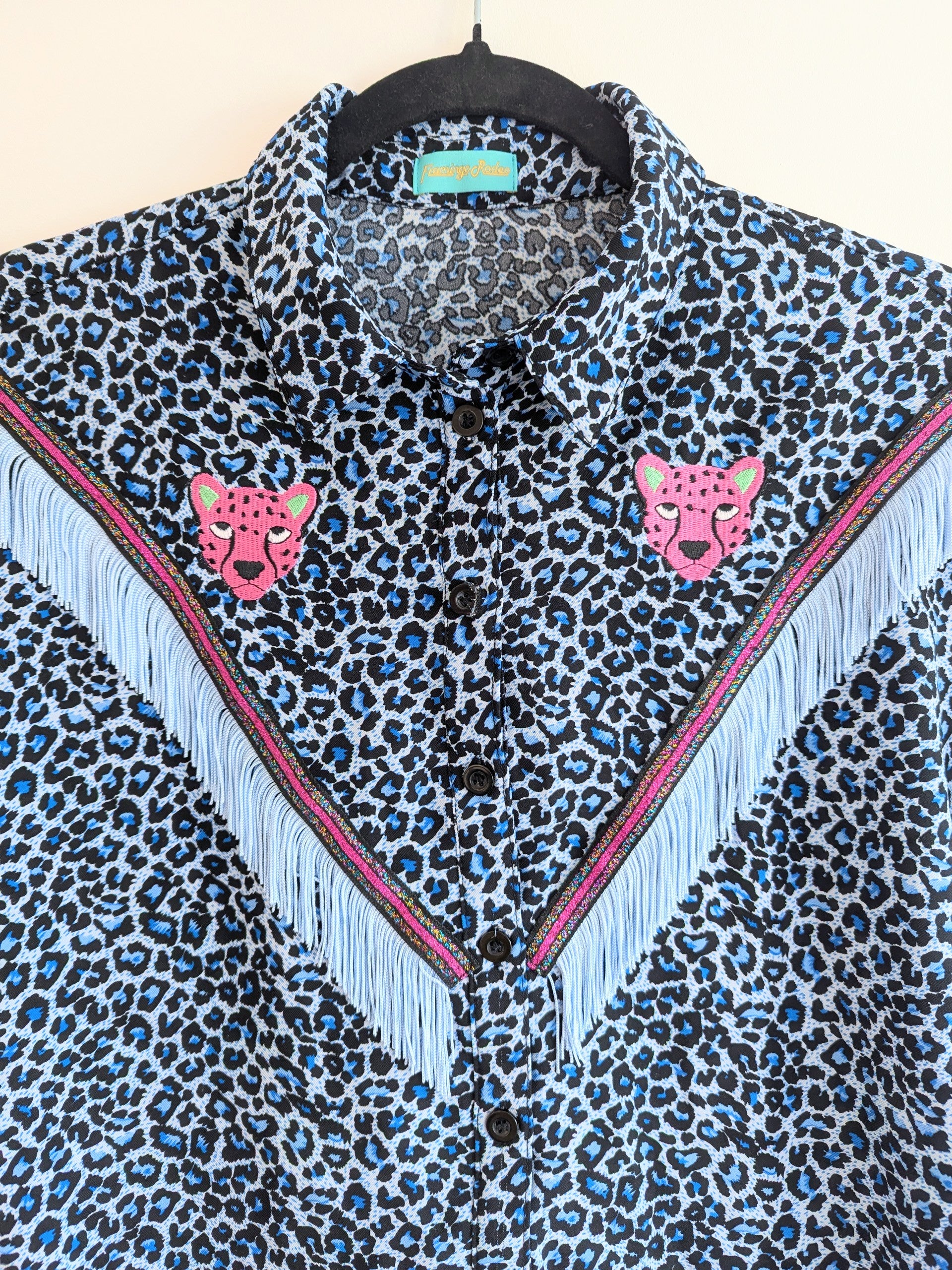blue leopard print shirt with embroidery pink leopard faces above cowboy western style fringe trim