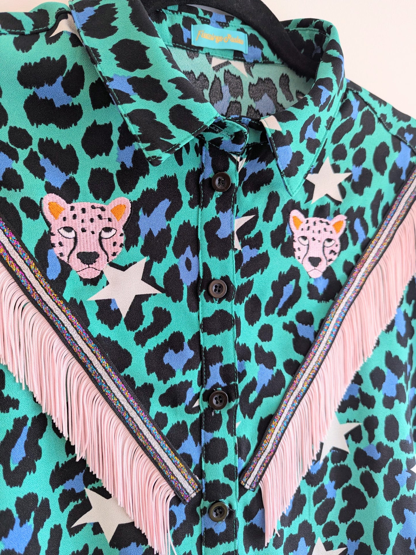 Green shirt with leopard print and star patterns. It has embroidery pink leopards and western style pale pink fringe trim added.