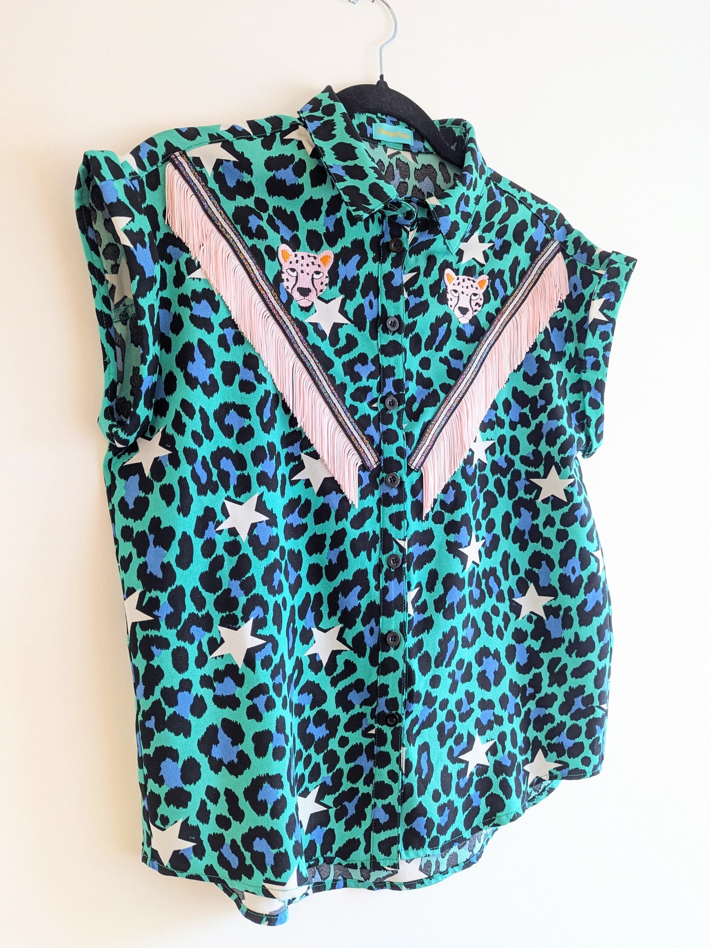 Green shirt with leopard print and star patterns. It has embroidery pink leopards and western style pale pink fringe trim added.