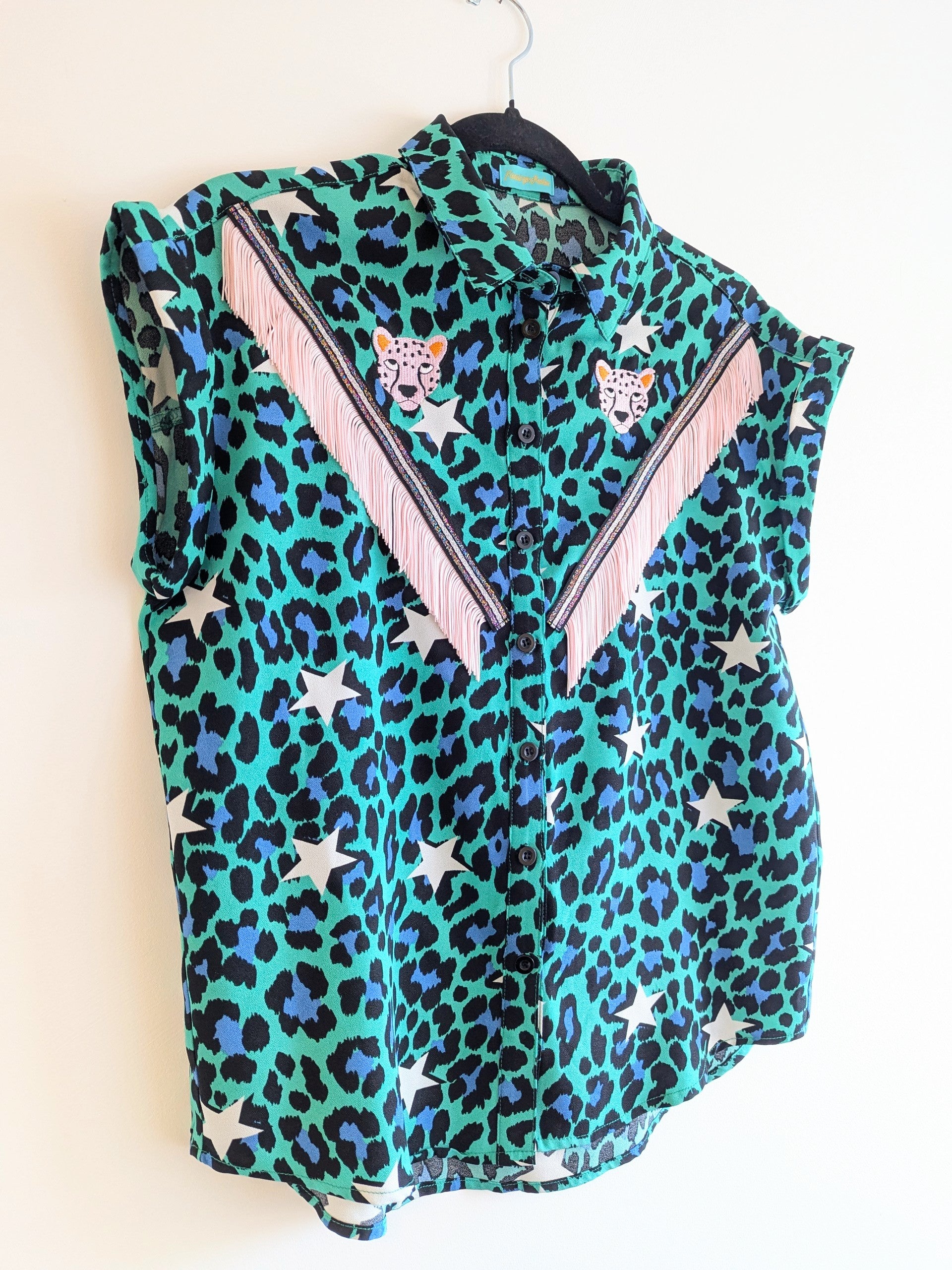 Green shirt with leopard print and star patterns. It has embroidery pink leopards and western style pale pink fringe trim added.