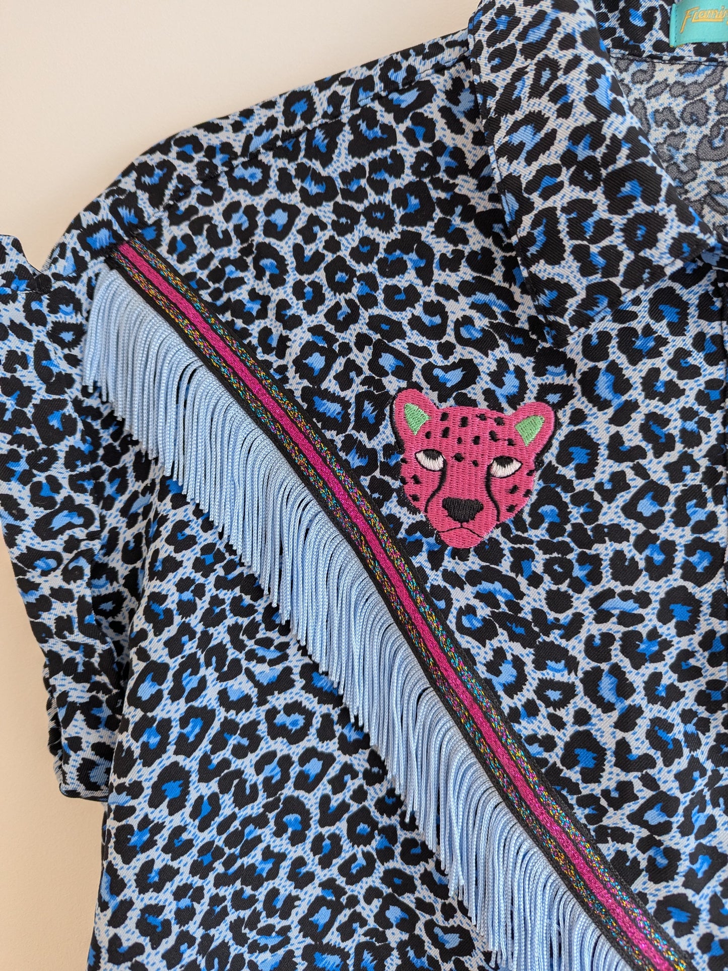 blue leopard print shirt with embroidery pink leopard faces above cowboy western style fringe trim